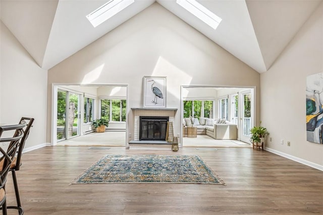 26 Bagy Wrinkle Cv, Warren, RI 02885 - living room with a skylight, a brick fireplace, high vaulted ceiling, and baseboards