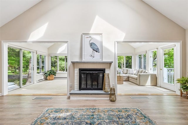 26 Bagy Wrinkle Cv, Warren, RI 02885 - living area featuring a brick fireplace, wood finished floors, and high vaulted ceiling