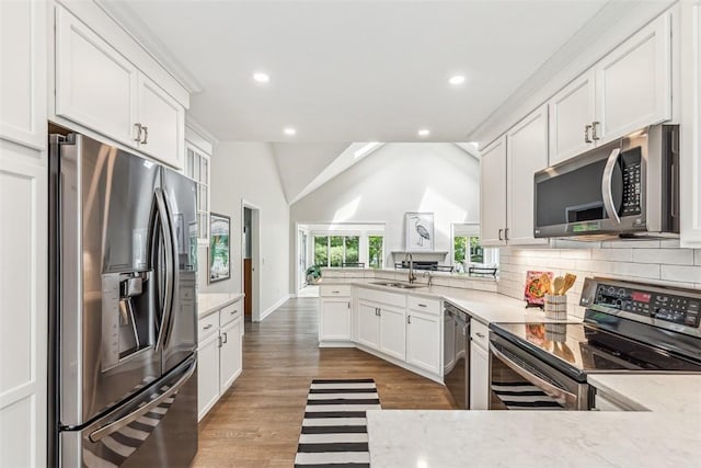 26 Bagy Wrinkle Cv, Warren, RI 02885 - kitchen featuring appliances with stainless steel finishes, a peninsula, a sink, white cabinets, and recessed lighting