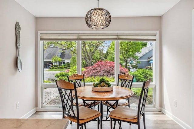 26 Bagy Wrinkle Cv, Warren, RI 02885 - dining area featuring baseboards, a chandelier, and light wood-type flooring