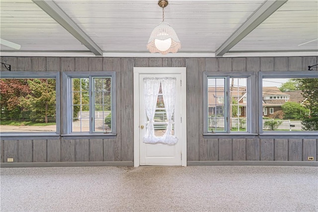 43 Standish Rd, Jamestown, RI 02835 - entrance foyer with beam ceiling, wooden walls, and carpet flooring