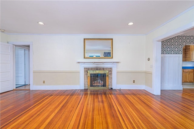 43 Standish Rd, Jamestown, RI 02835 - unfurnished living room featuring wood finished floors, crown molding, a brick fireplace, recessed lighting, and baseboards