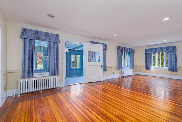 43 Standish Rd, Jamestown, RI 02835 - empty room with radiator heating unit, wood finished floors, crown molding, and recessed lighting
