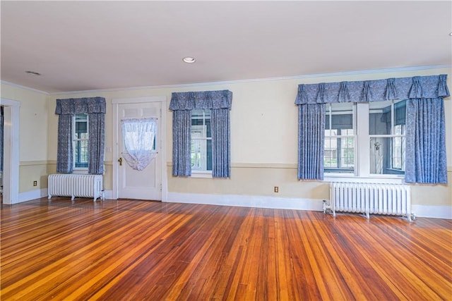 43 Standish Rd, Jamestown, RI 02835 - entryway with radiator heating unit, wood finished floors, and crown molding