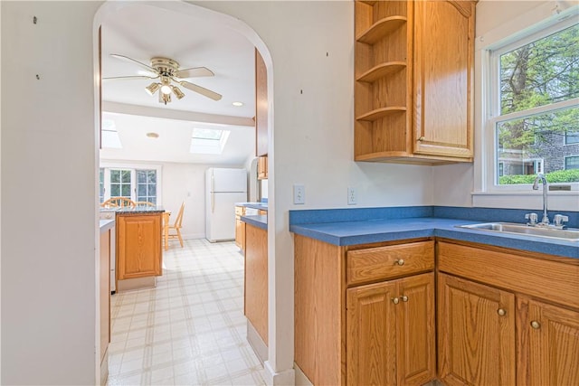 43 Standish Rd, Jamestown, RI 02835 - kitchen featuring a sink, freestanding refrigerator, light flooring, a skylight, and open shelves