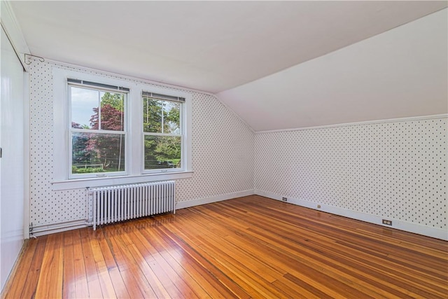 43 Standish Rd, Jamestown, RI 02835 - bonus room featuring radiator heating unit, wallpapered walls, light wood-type flooring, baseboards, and lofted ceiling