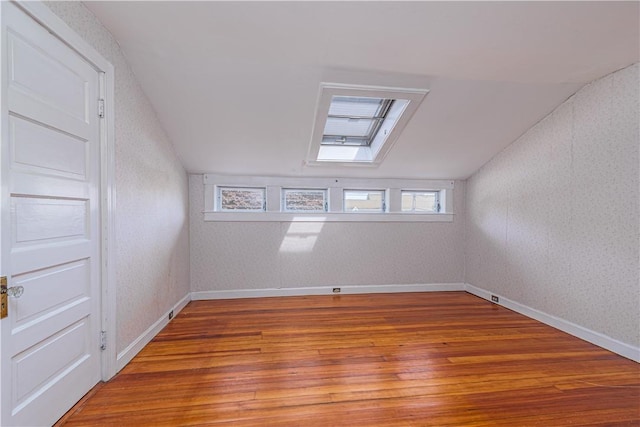 43 Standish Rd, Jamestown, RI 02835 - bonus room featuring lofted ceiling, hardwood / wood-style floors, healthy amount of natural light, baseboards, and wallpapered walls