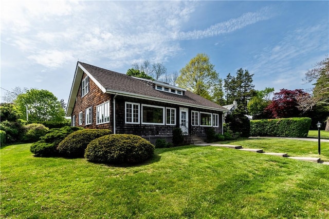 43 Standish Rd, Jamestown, RI 02835 - view of front of house with a front yard and a shingled roof