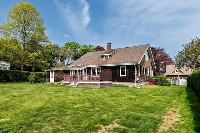 43 Standish Rd, Jamestown, RI 02835 - back of property with a chimney and a wooden deck