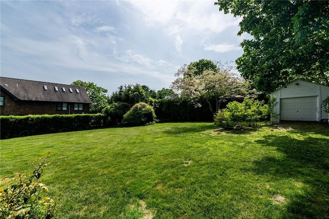 43 Standish Rd, Jamestown, RI 02835 - view of green lawn with an outdoor structure and a garage