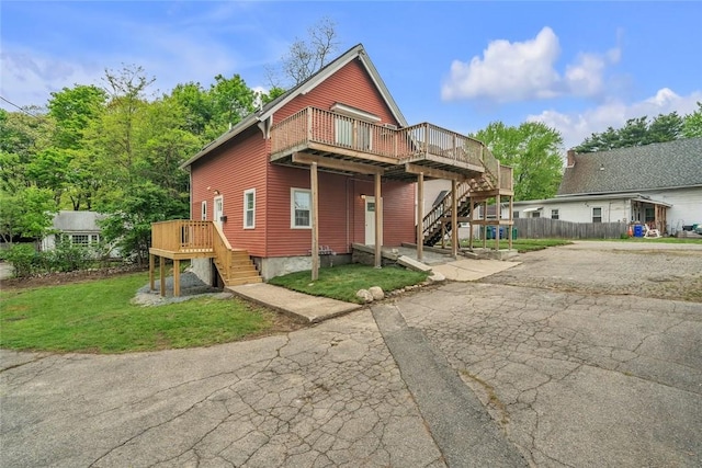 view of front of home with stairway and a deck