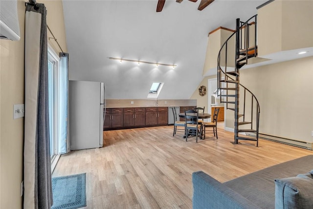 living room with light wood finished floors, stairway, lofted ceiling, rail lighting, and a baseboard heating unit
