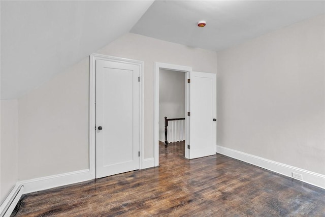 bonus room featuring baseboard heating, wood finished floors, vaulted ceiling, and baseboards