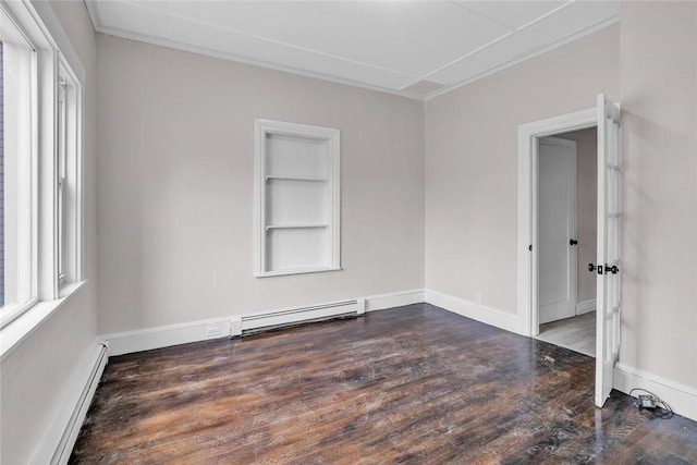 empty room featuring baseboard heating, a baseboard heating unit, wood finished floors, built in shelves, and crown molding