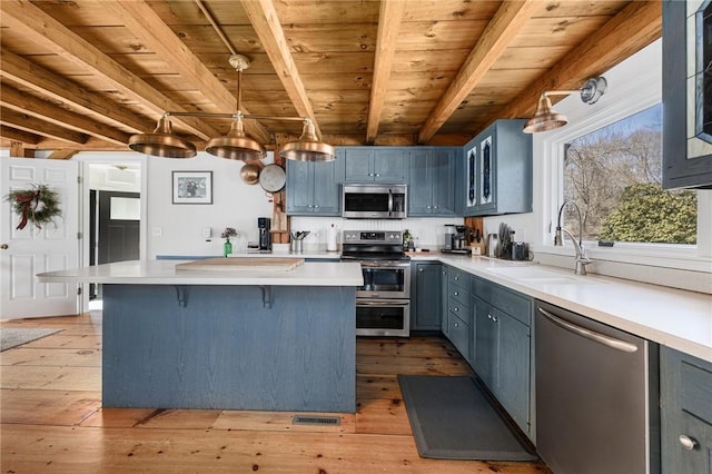 40 Charlotte Ave, North Kingstown, RI 02874 - kitchen with appliances with stainless steel finishes, a sink, wood ceiling, a kitchen breakfast bar, and light countertops