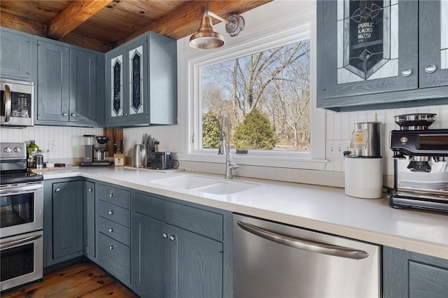 40 Charlotte Ave, North Kingstown, RI 02874 - kitchen featuring stainless steel appliances, wood ceiling, a sink, beam ceiling, and light countertops