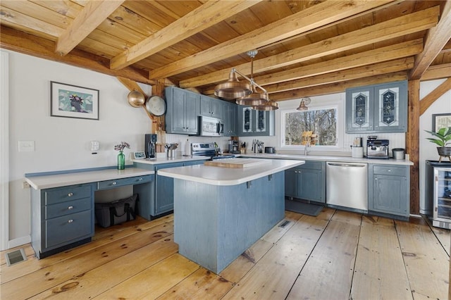 40 Charlotte Ave, North Kingstown, RI 02874 - kitchen featuring stainless steel appliances, wood ceiling, beam ceiling, blue cabinets, and light countertops