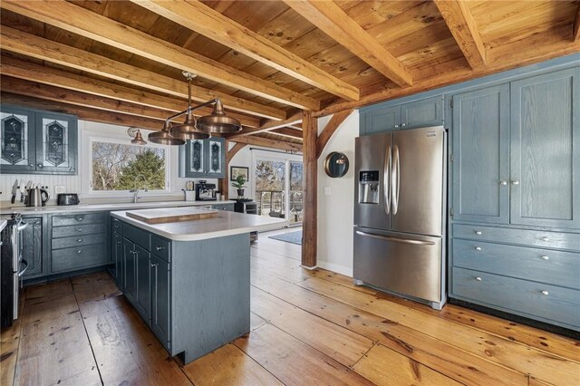 40 Charlotte Ave, North Kingstown, RI 02874 - kitchen with stainless steel fridge with ice dispenser, light wood-style floors, glass insert cabinets, wooden ceiling, and light countertops