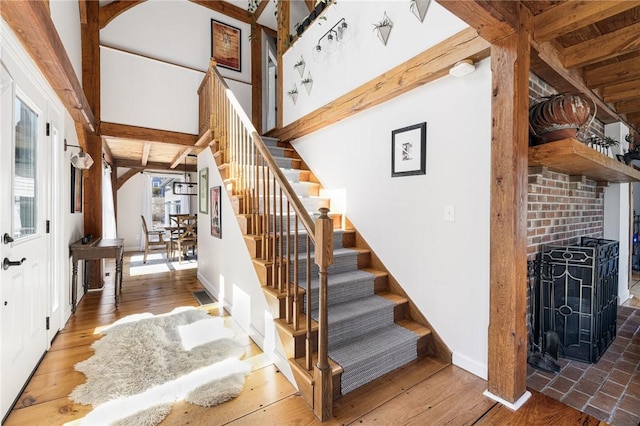 40 Charlotte Ave, North Kingstown, RI 02874 - staircase featuring baseboards, wood finished floors, and a wood stove