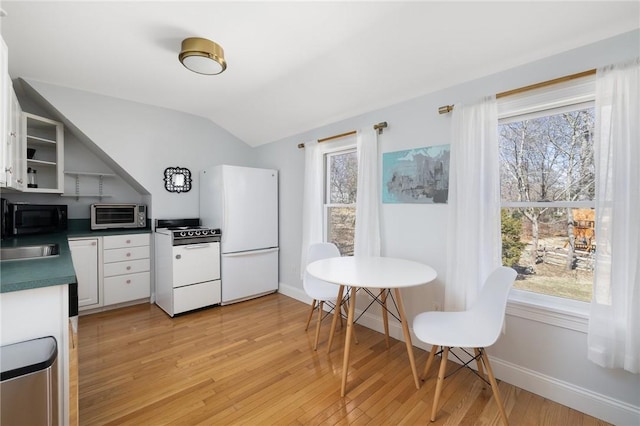 40 Charlotte Ave, North Kingstown, RI 02874 - kitchen with white appliances, open shelves, light wood-type flooring, vaulted ceiling, and plenty of natural light