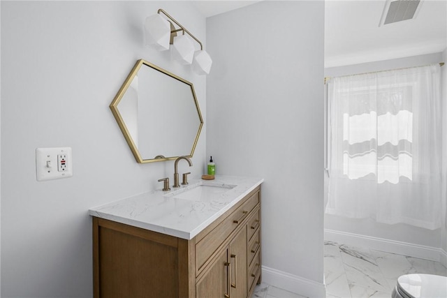 40 Charlotte Ave, North Kingstown, RI 02874 - bathroom with marble look tile flooring, vanity, and baseboards