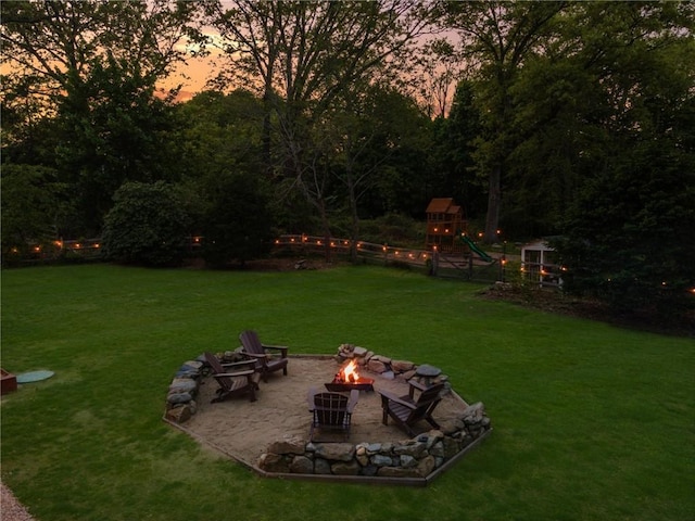 40 Charlotte Ave, North Kingstown, RI 02874 - view of grassy yard with an outdoor fire pit, a playground, and a patio