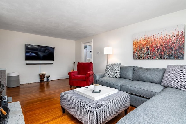 living area featuring wood finished floors and baseboards