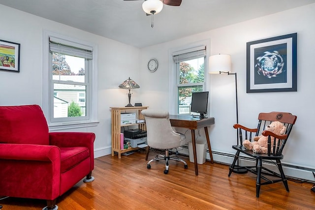 office area featuring wood finished floors, a ceiling fan, and baseboards