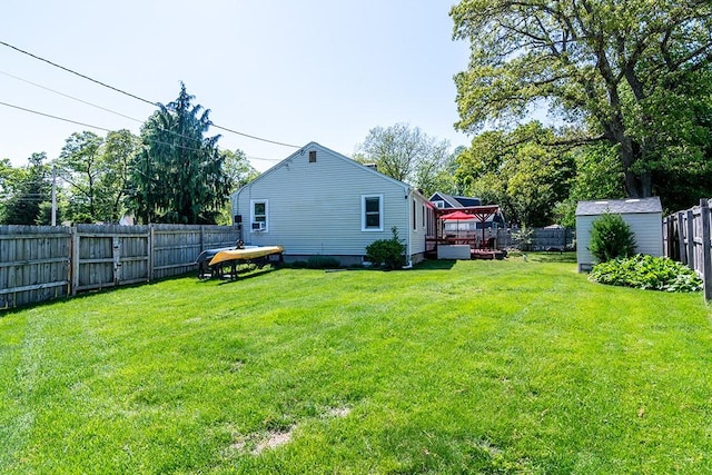 view of yard with a storage shed, a wooden deck, and an outdoor structure