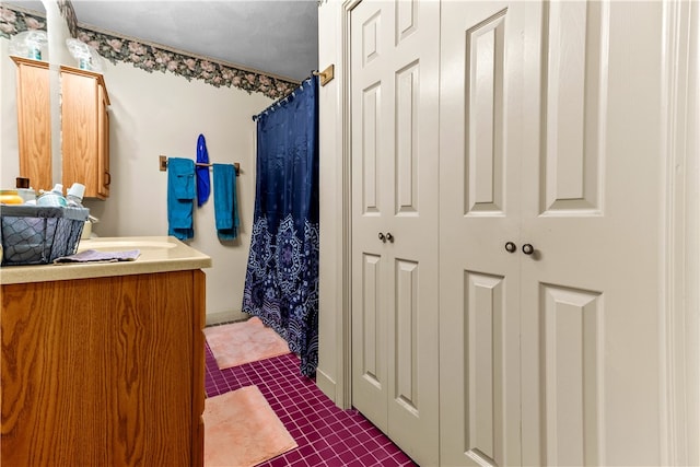 full bath featuring tile patterned flooring, a shower with shower curtain, and vanity