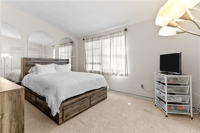 carpeted bedroom with vaulted ceiling and baseboards