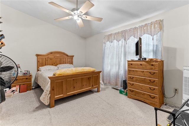 carpeted bedroom with lofted ceiling and a ceiling fan