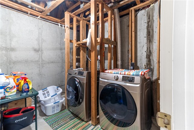 clothes washing area featuring washer and clothes dryer