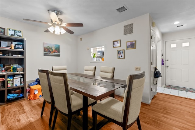 dining room with light wood-style floors and ceiling fan