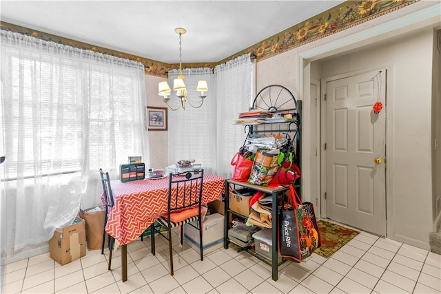 dining room featuring a chandelier and light tile patterned floors