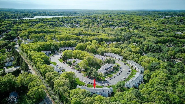 aerial view of property and surrounding area featuring a forest
