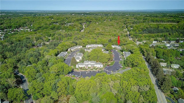 aerial view of property's location with a heavily wooded area