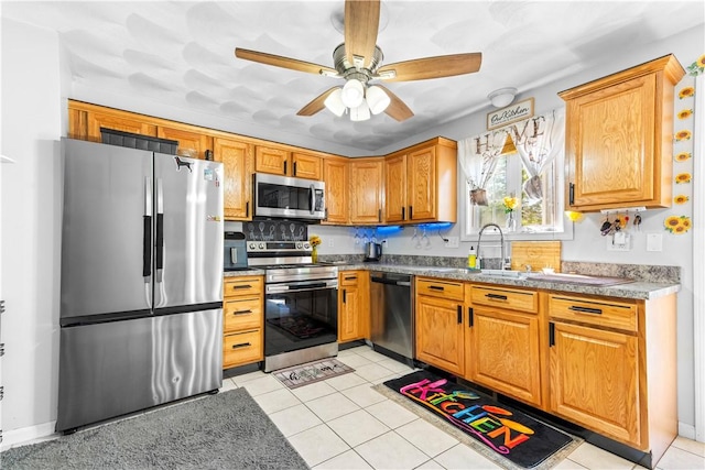 151 Bend St S Unit 2, Pawtucket, RI 02860 - kitchen featuring stainless steel appliances, ceiling fan, light tile patterned flooring, and brown cabinets