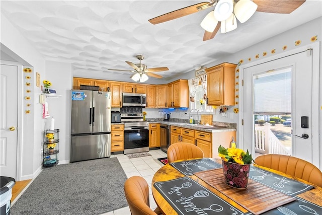 151 Bend St S Unit 2, Pawtucket, RI 02860 - kitchen featuring appliances with stainless steel finishes, ceiling fan, a sink, light tile patterned floors, and decorative backsplash