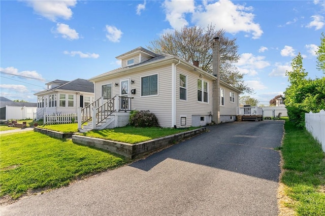 95 Vincent Ave, North Providence, RI 02904 - view of front of house with asphalt driveway and a chimney