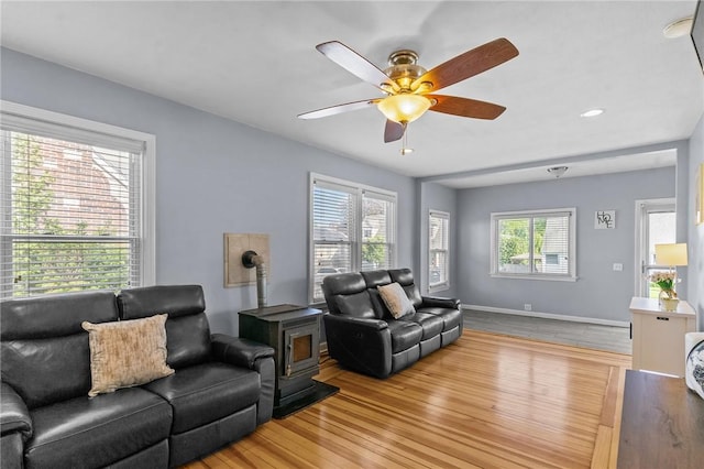 95 Vincent Ave, North Providence, RI 02904 - living area with a wood stove, ceiling fan, wood finished floors, baseboards, and recessed lighting