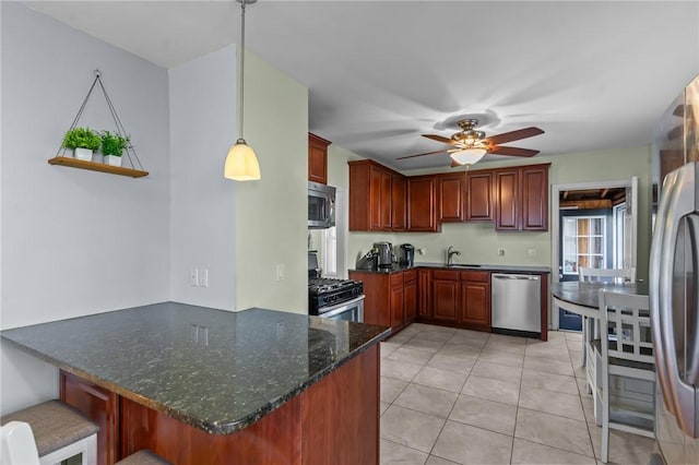 95 Vincent Ave, North Providence, RI 02904 - kitchen with appliances with stainless steel finishes, a peninsula, ceiling fan, and dark brown cabinets