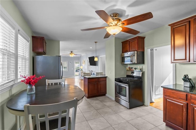 95 Vincent Ave, North Providence, RI 02904 - kitchen featuring appliances with stainless steel finishes, ceiling fan, light tile patterned flooring, decorative light fixtures, and reddish brown cabinets