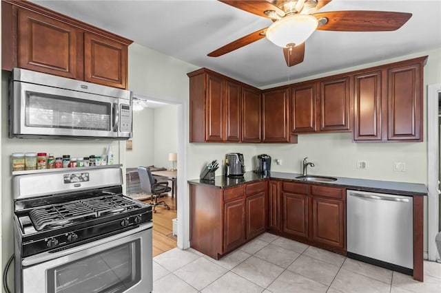 95 Vincent Ave, North Providence, RI 02904 - kitchen with stainless steel appliances, a ceiling fan, a sink, light tile patterned flooring, and dark stone counters