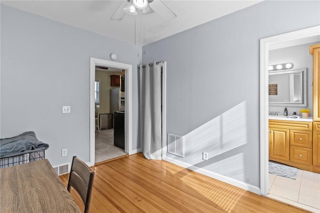 95 Vincent Ave, North Providence, RI 02904 - bedroom with light wood-style floors, ensuite bath, baseboards, a sink, and a ceiling fan