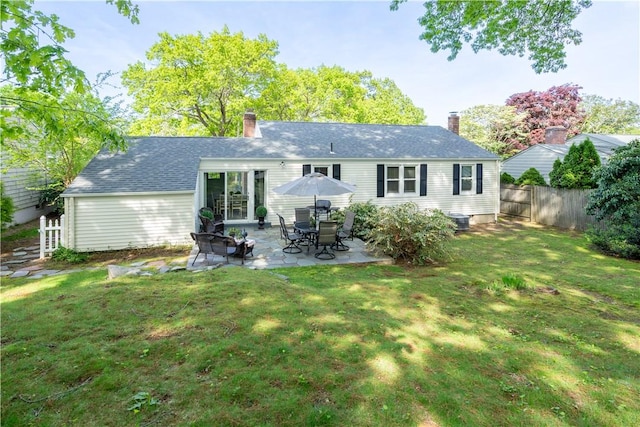 33 Perennial Dr, Cranston, RI 02920 - back of property with a chimney, a patio, central AC unit, and roof with shingles