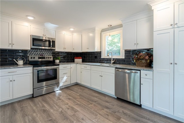 33 Perennial Dr, Cranston, RI 02920 - kitchen featuring appliances with stainless steel finishes, a sink, wood finished floors, and tasteful backsplash