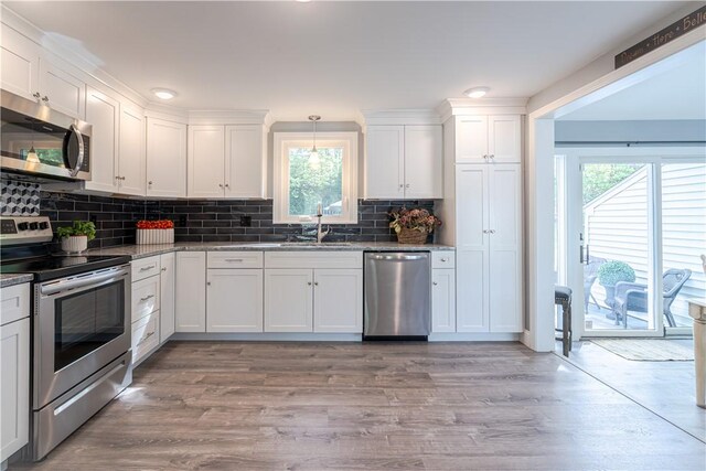 33 Perennial Dr, Cranston, RI 02920 - kitchen with stainless steel appliances, white cabinetry, tasteful backsplash, and light wood-style floors
