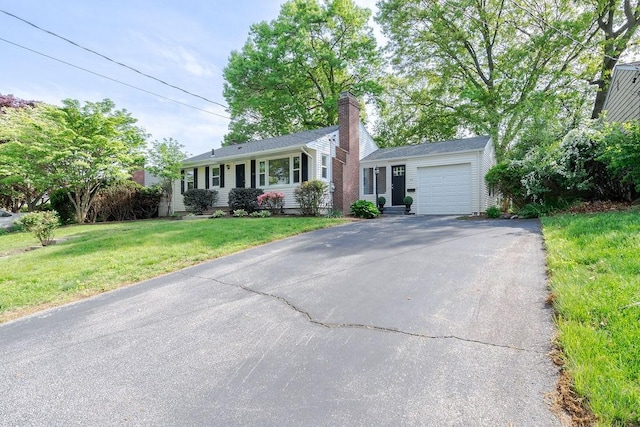 33 Perennial Dr, Cranston, RI 02920 - view of front of property featuring driveway, an attached garage, a front lawn, and a chimney