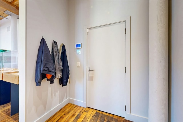 foyer entrance featuring wood-type flooring and baseboards